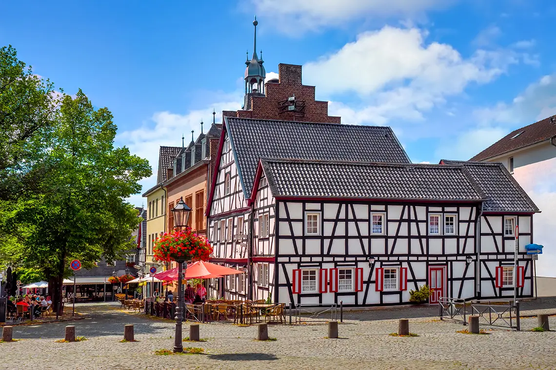 Fachwerkhäuser und Straßencafés am historischen Marktplatz in Bad Honnef bei sonnigem Wetter. Fachwerkhäuser und Straßencafés am historischen Marktplatz in Bad Honnef bei sonnigem Wetter.